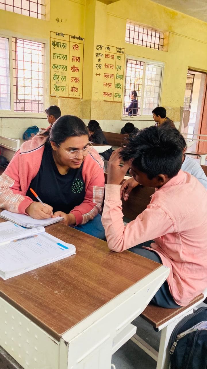 Volunteer explaining concept to children