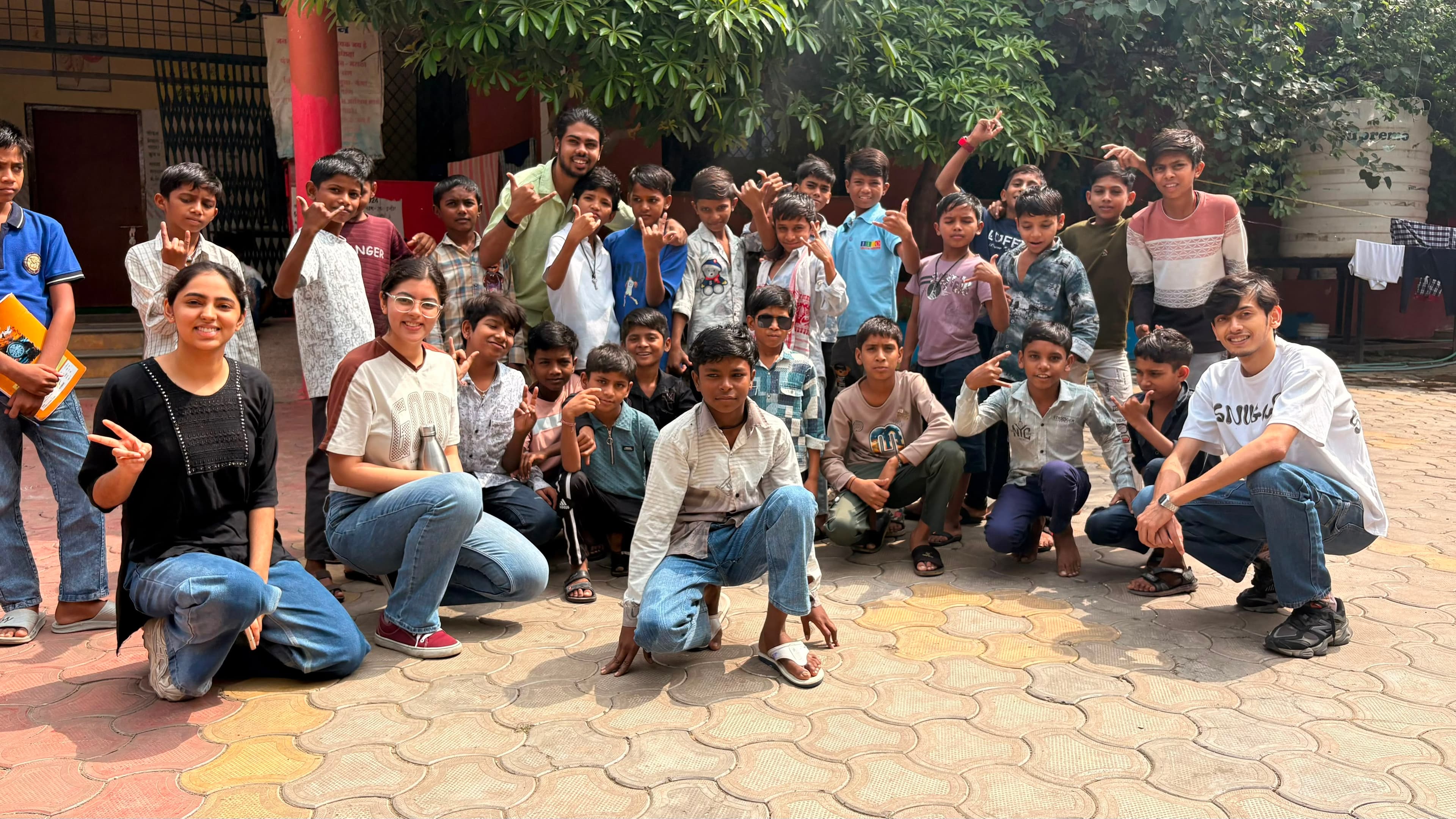 Volunteers posing with children after classes